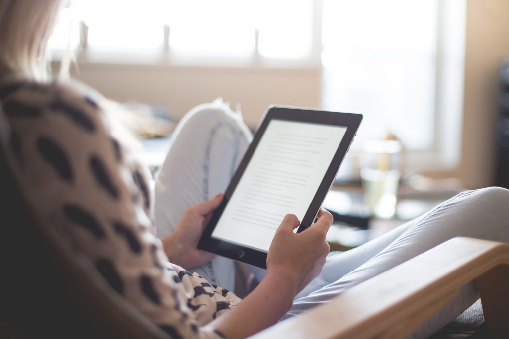 Woman reading on a Kindle