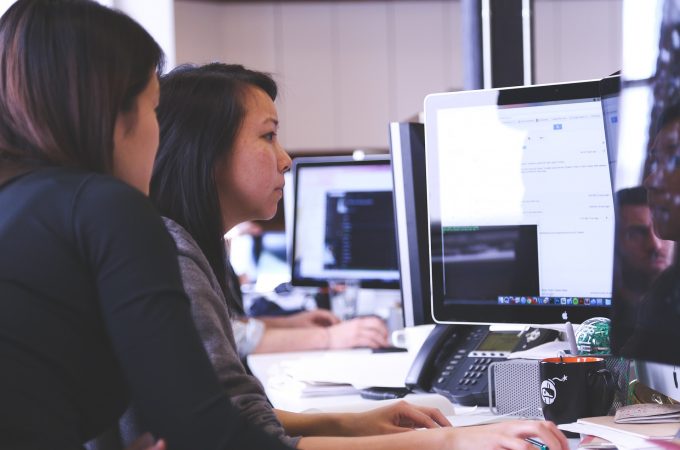 Two women working on a computer