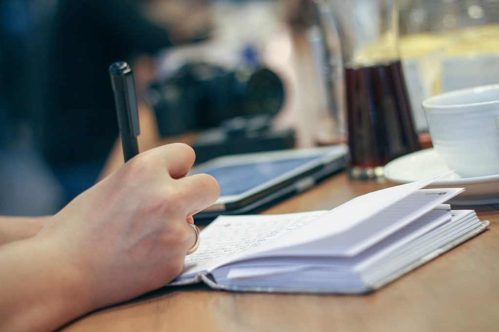 Person writing in a notebook