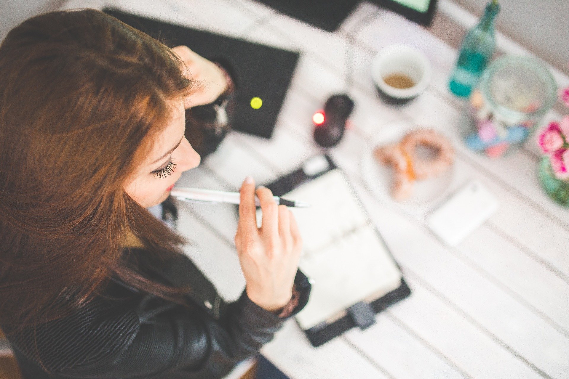 Woman writing in a planner