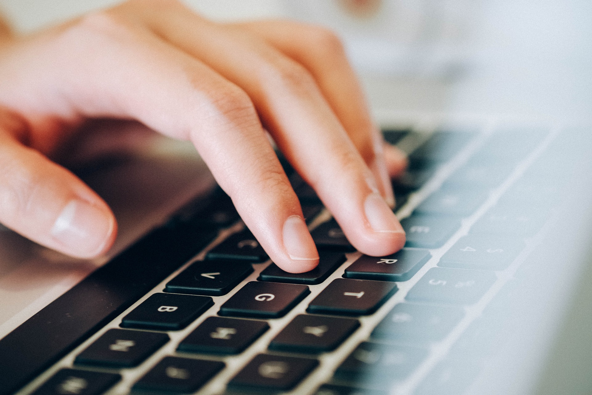 Person typing on a keyboard